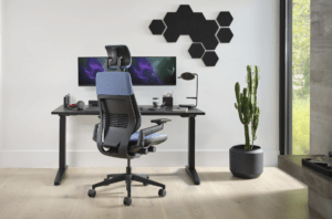 Steelcase Gesture with Headrest gaming chair at a desk in a modern looking room with a cactus plan next to the desk